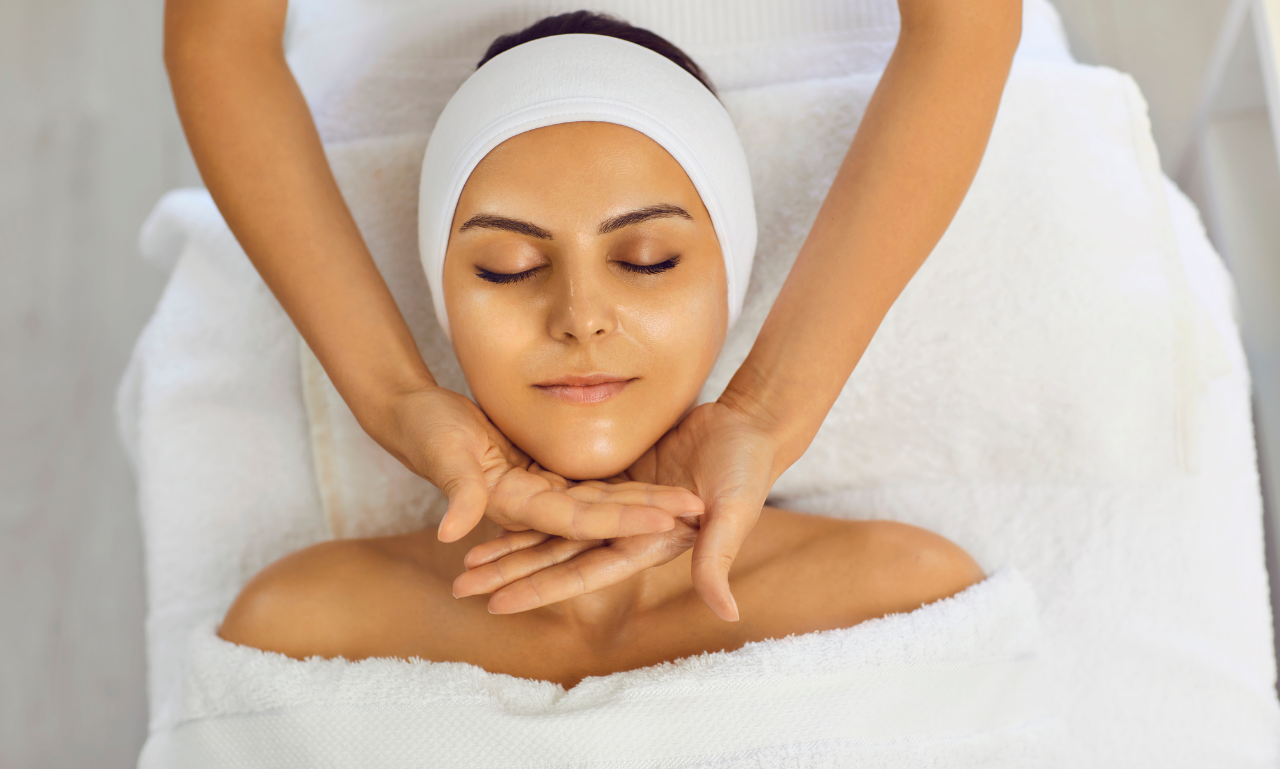 glokss8 Woman receiving relaxing facial massage at spa