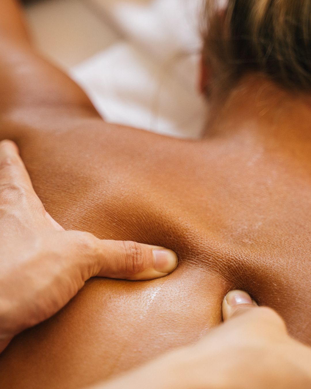 5 Person receiving shoulder massage on massage table
